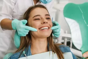 Happy patient smiling on dental chair in Lancaster, CA