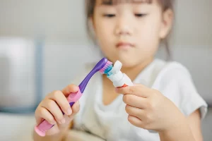 Lovely child brushing her teeth