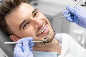 Male patient getting dental check in Lancaster, CA