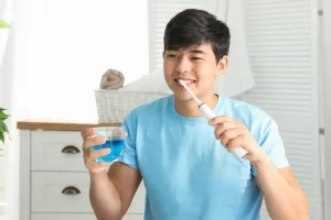 Young male patient brushing teeth in Lancaster, CA