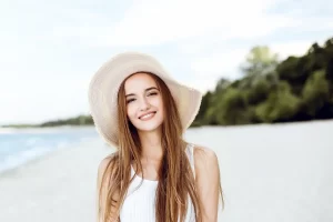 Patient at the beach with beautiful healthy smile