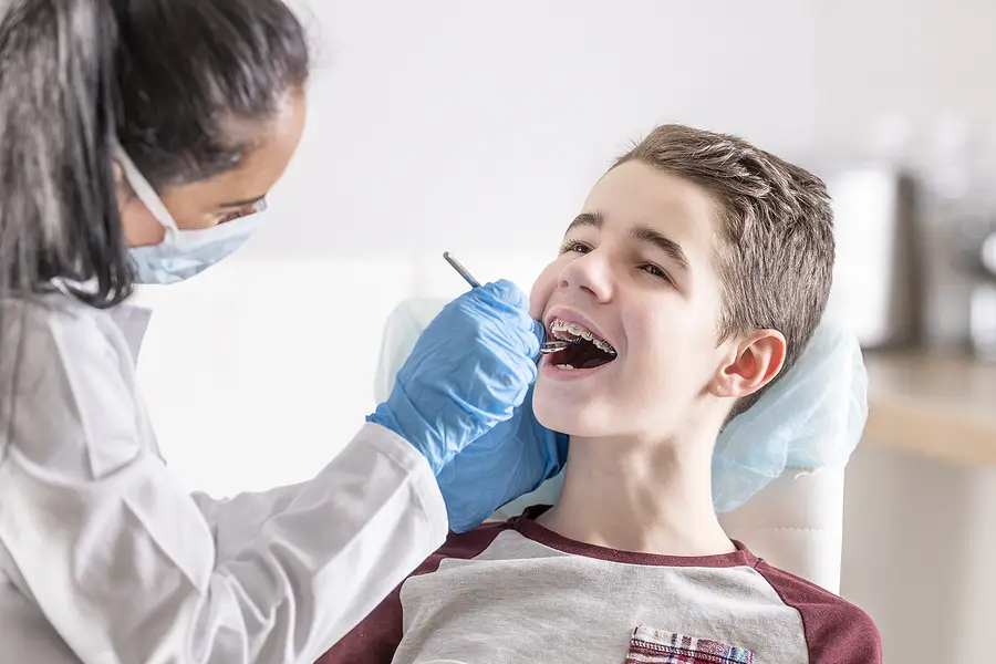 Dentist checking kids oral health