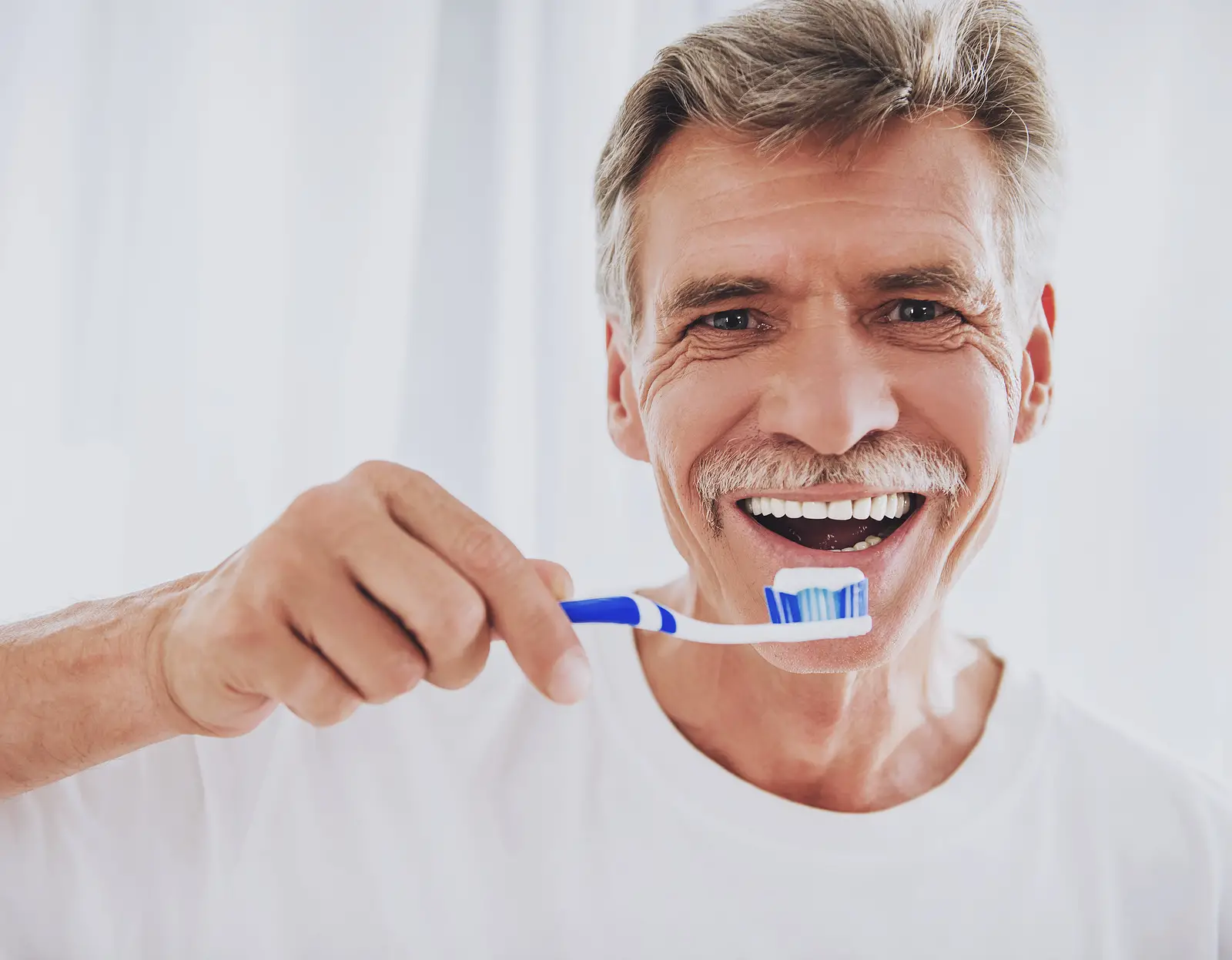 Male patient brushing teeth