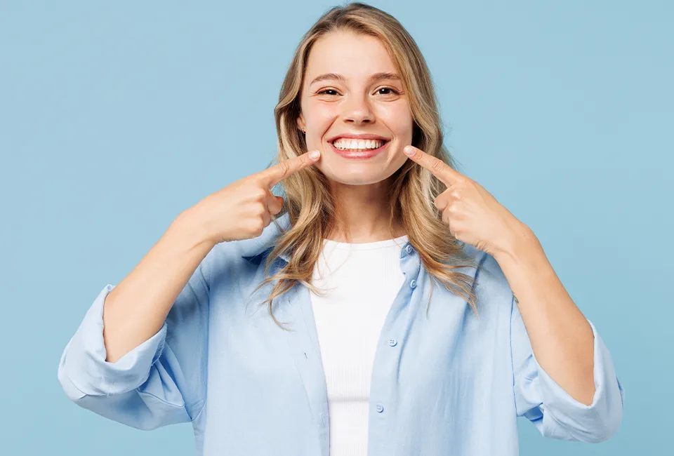 Patient pointing at her great healthy smile